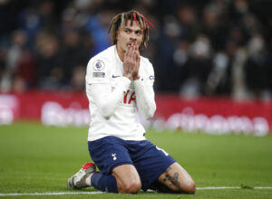 Tottenhams Dele Alli tager sig til ansigtet under den tætte kamp mod Liverpool FC.