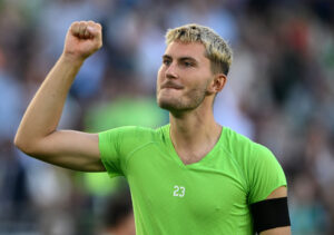 Jonas Wind med en arm i vejret iført grøn trøje