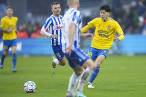 Tom Trybull jagter en bold for OB mod Brøndby