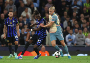 Yann Bisseck i nærkamp med Erling Haaland.