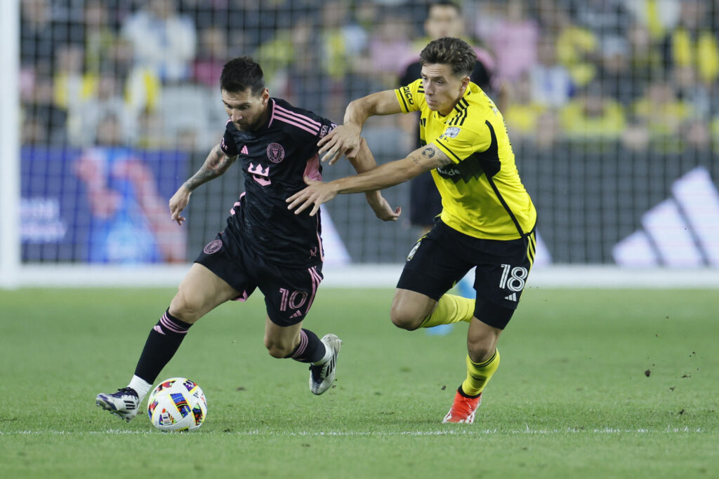 Inter Miami's Lionel Messi, left, and Columbus Crew's Malte Amundsen chase the ball during the second half of an MLS soccer match, Wednesday, Oct. 2, 2024, in Columbus, Ohio.