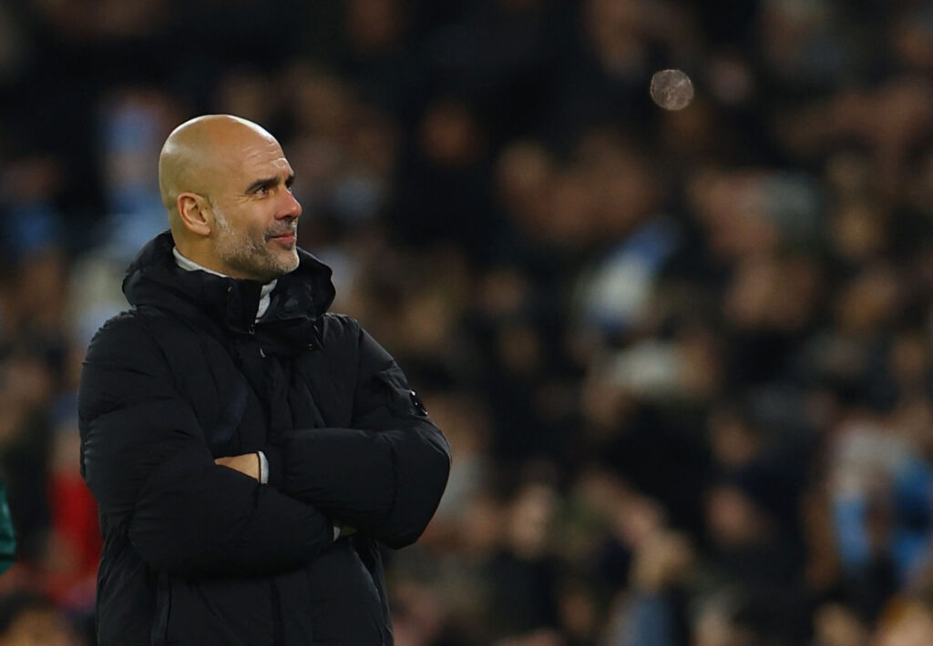 Pep Guardiola smiler under kampen mellem Manchester City og Feyenoord i Champions League.