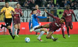 Armin Gigovic tackler Lois Openda.