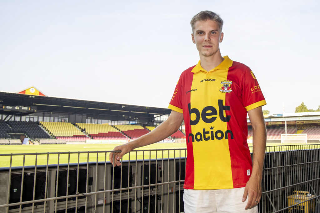 Oliver Antman iklædt en Go Ahead Eagles-trøje ved siden af banen.