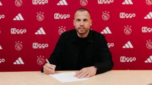 John Heitinga underskriver sin kontrakt med Ajax.