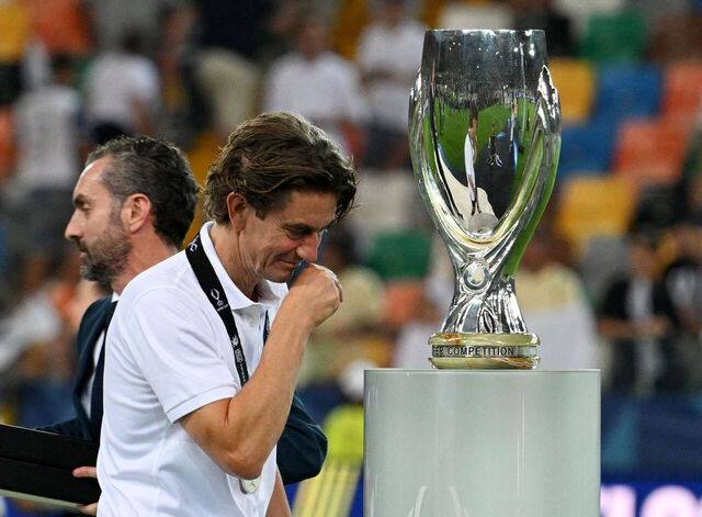 Thomas Frank går med bøjet hoved forbi Super Cup-trofæet.