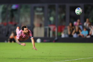 Lionel Messi flyvende i luften efter et hovedstød.