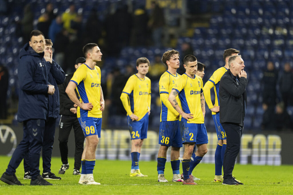 Skuffede Brøndby spillere kigger ud på fans sammen med cheftræner Steve Cooper