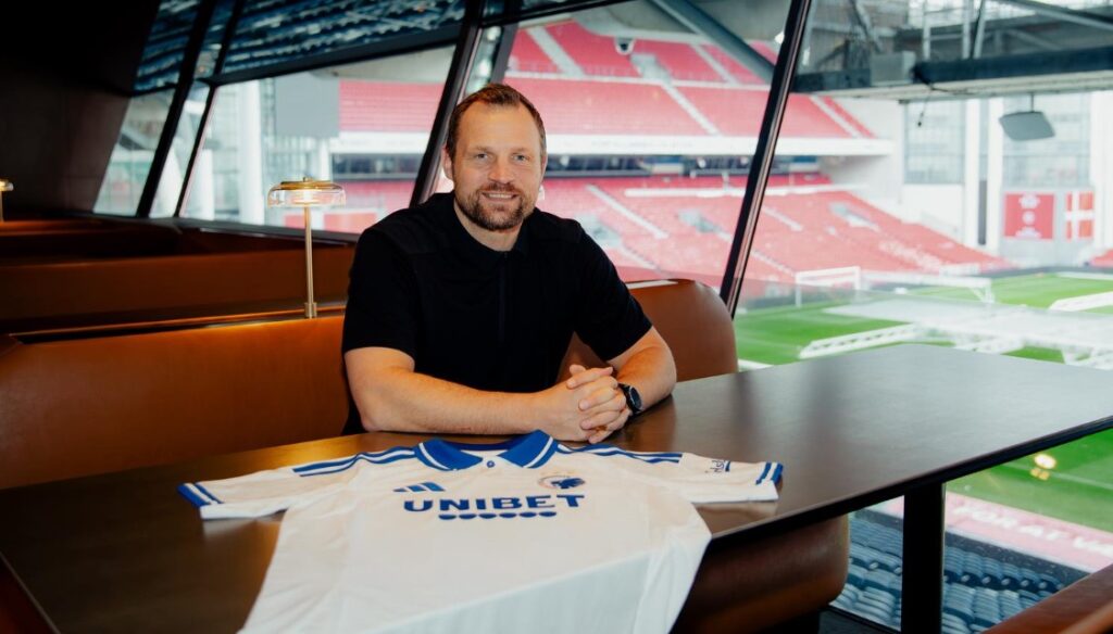 Bo Svensson med en FCK-trøje foran sig inde i Parken.