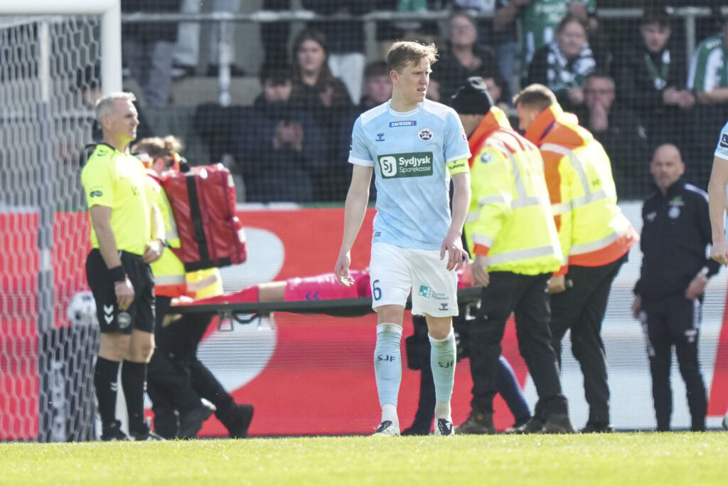 Marcus Bundgaard bæres fra banen på en båre.