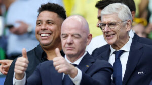 Gianni Infantino med to tommelfingre op med Arsene Wenger i baggrunden.
