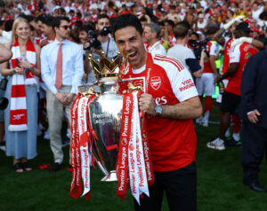Mikel Arteta bider i Premier League-trofæet.